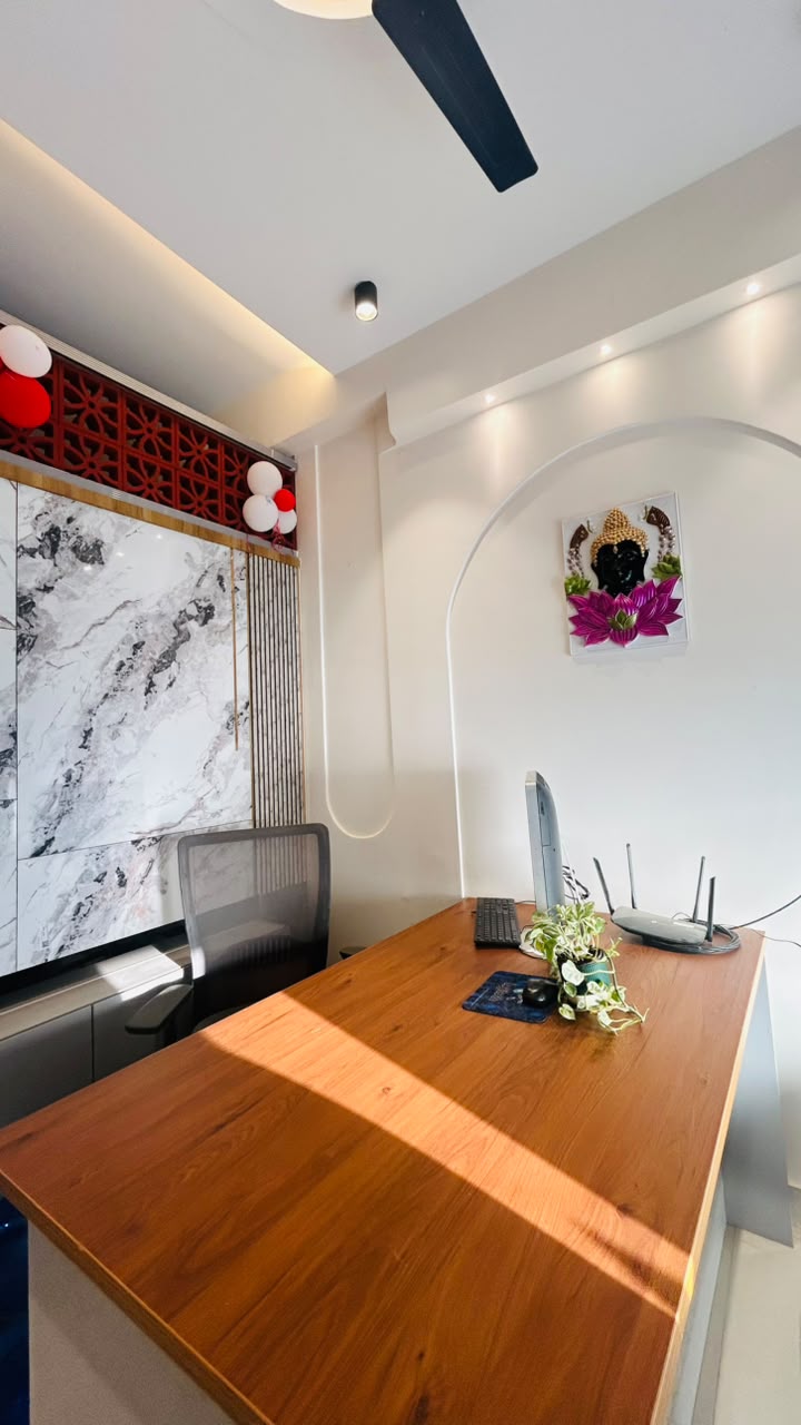 Vasvik Interiors office — design desk with marble feature wall